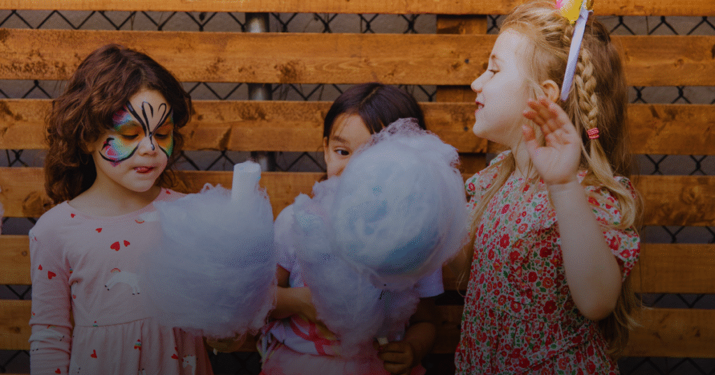 Girls eating candy and enjoying their party with friends.