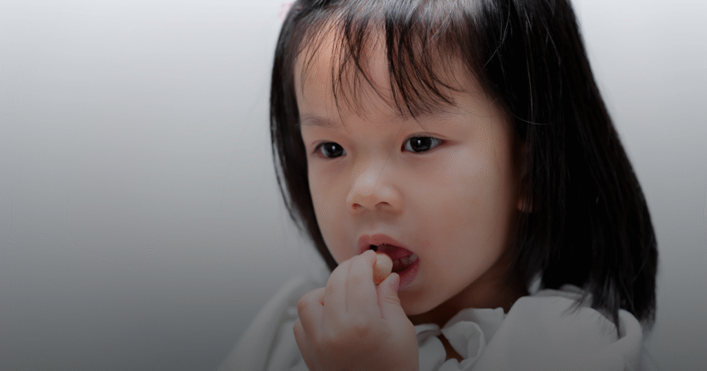 A girl eating candy.