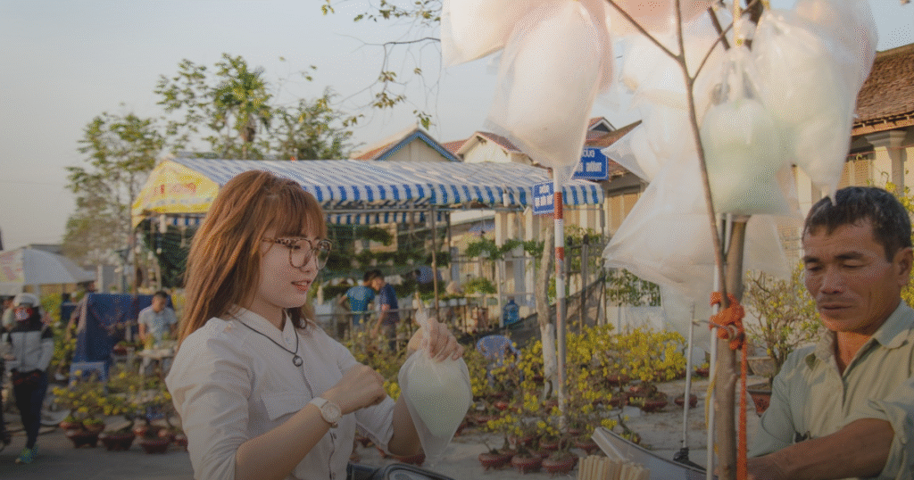 A woman in a white shirt stands confidently, showcasing a casual yet professional appearance.