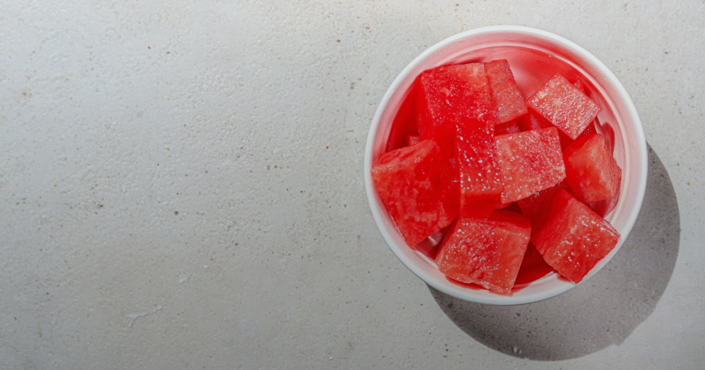 A colorful bowl of watermelon cubes displayed on a table, ready to be served.