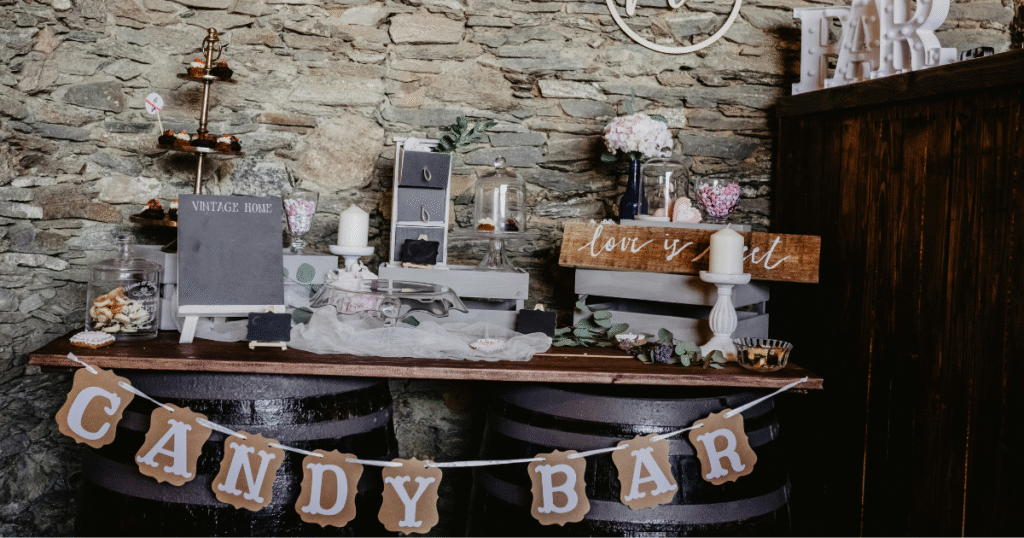 A beautifully arranged wedding candy bar featuring various colorful sweets and treats in elegant glass containers.