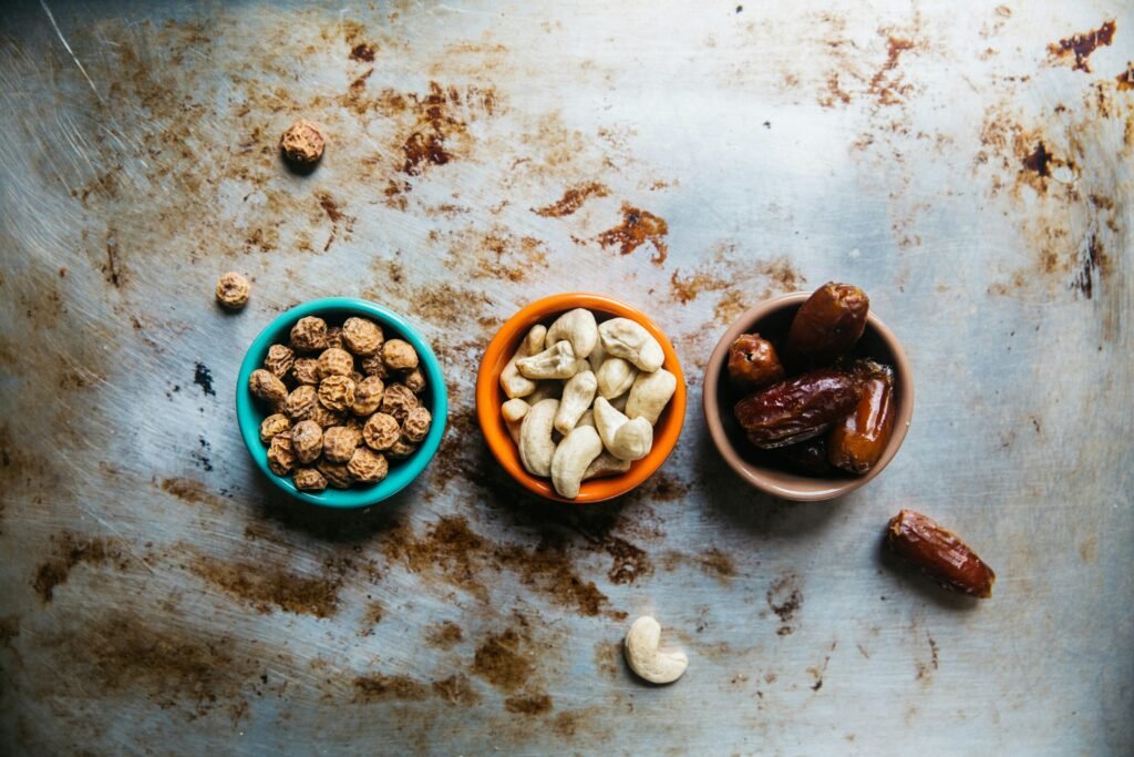 A black plate holds an assortment of chocolate bars and scattered coffee beans, creating a rich, indulgent display.